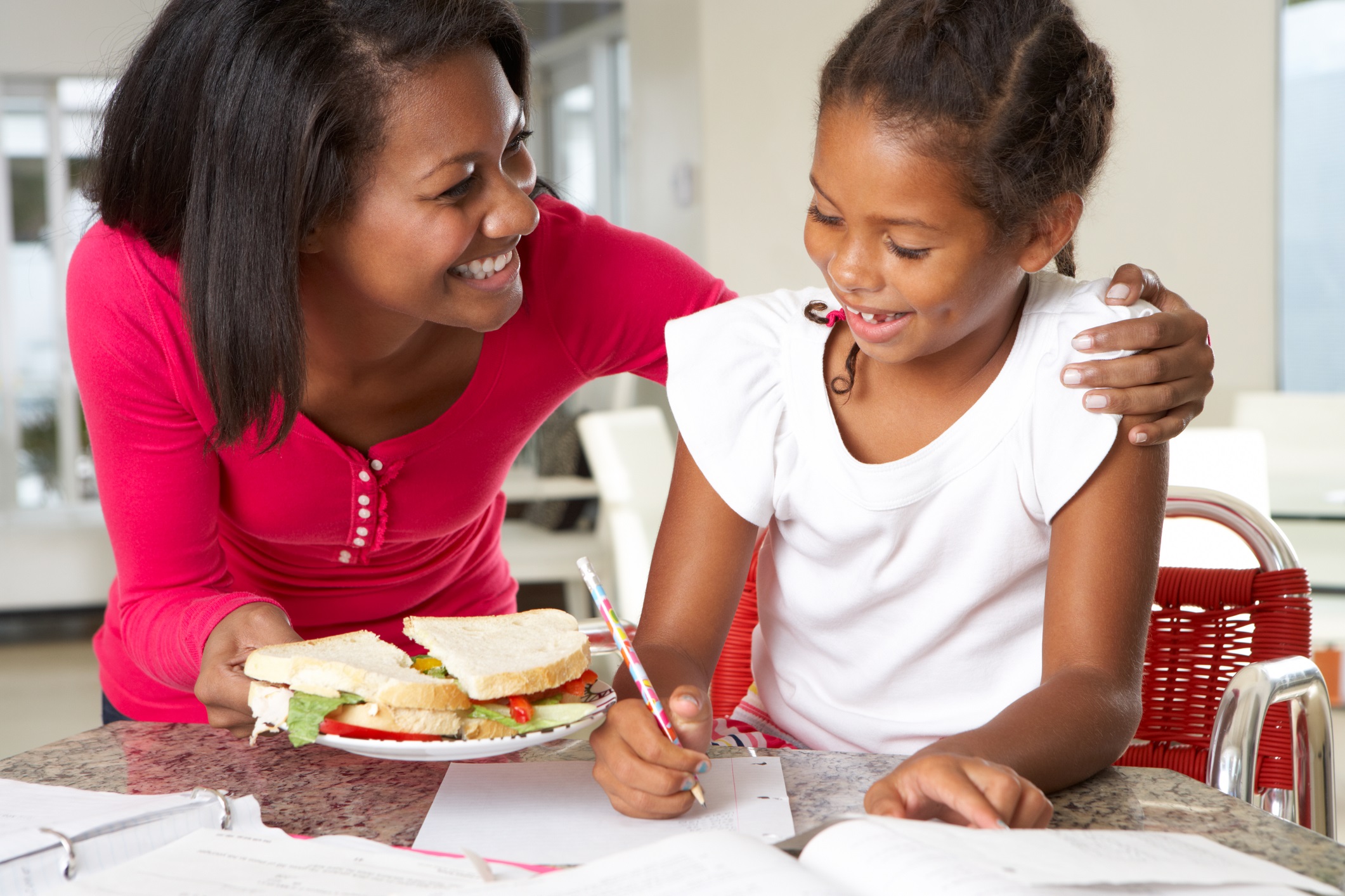 mother and daughter with afterschool snack-Monkeybusiness Images